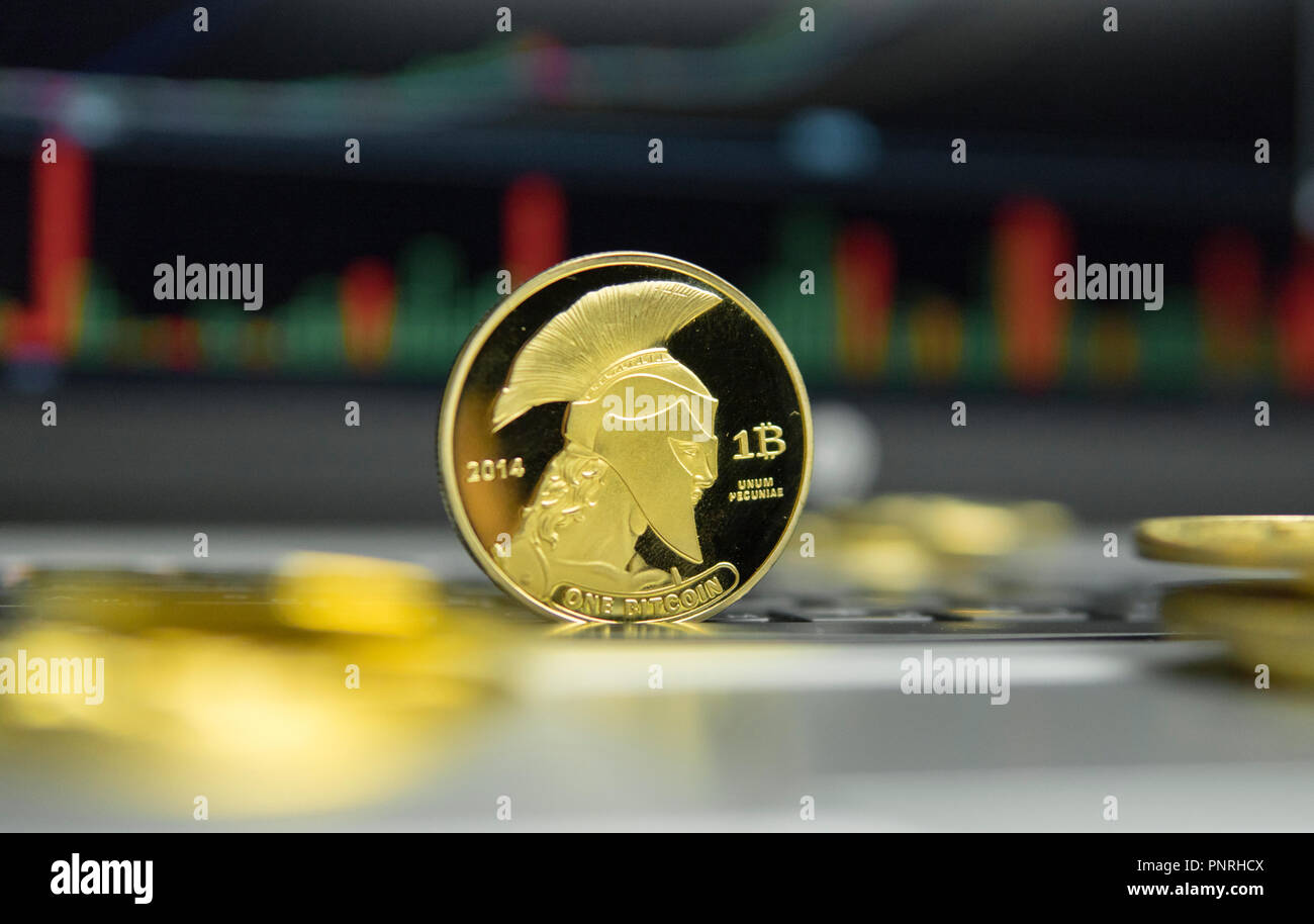 Golden Titan Bitcoin Coin With Gold Coins Lying Around On A Silver - 